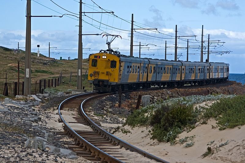 The end of the train is still in the last curve while the front almost reaches the next curve.