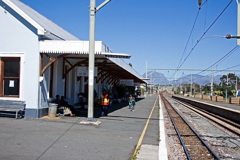 A closer view at the trackside of the building. There are already some people which are waiting for the next train.