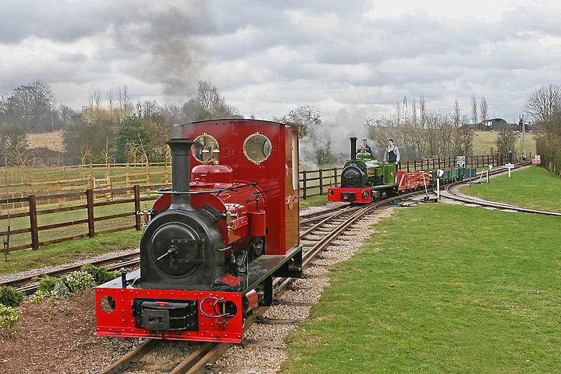 Hunslet Statfold stands in a siding whilst Jack Lane<br />overtakes on a freight. D Rogers 24 2010