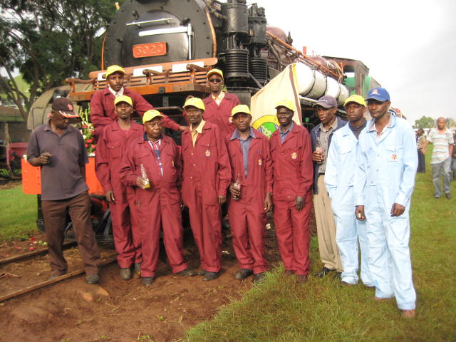 Kenya's steam team poses in front of 3020 at the wedding reception in the grounds of the railway museum