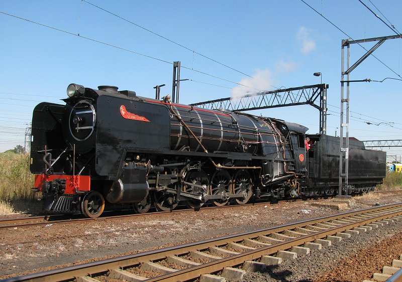 3046 waiting for the train to pass before picking up the last flat cars