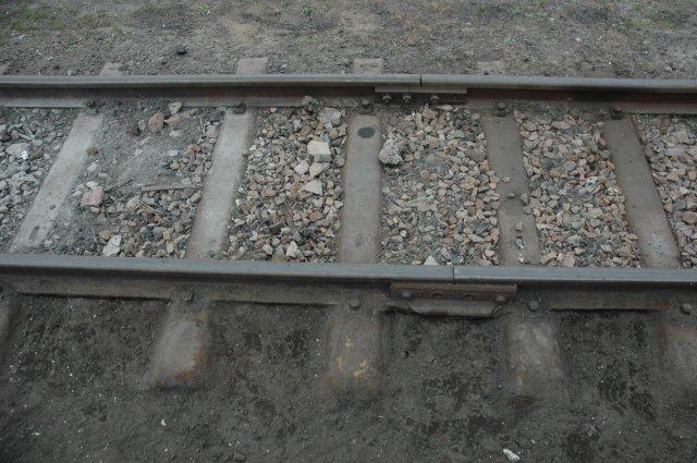 Clearing away the build up of sand and stone so that the steel sleepers are clearly visible. They will be painted with old motor car oil. Work still in progress