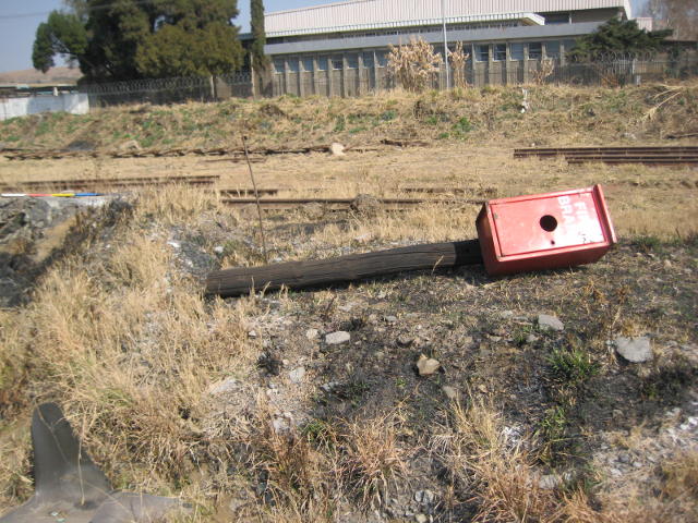 Fire extinguisher box mounted to a pole waiting to be erected at the western end of the site