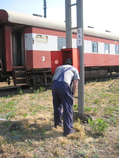 Headless man - Nathan inspects the inside of a newly-mounted fire extinguisher box