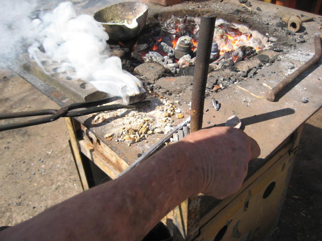 The heated plug is being cleaned with ammonium chloride, hence the smoke
