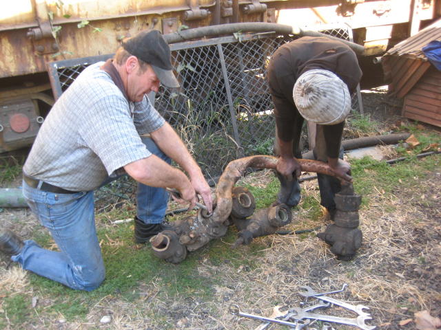 Les and John wrestle with the tangled and twisted pipework