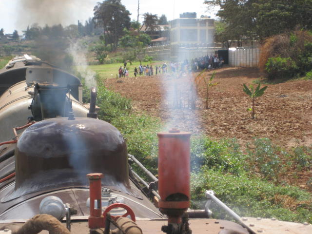 Mawenzi Gardens comes into view, with passengers awaiting the train