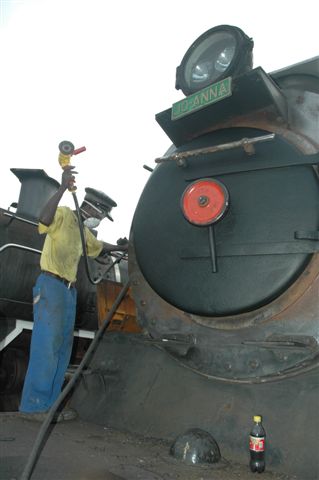 At the Friends site, work is being carried out on stalwart engine 3664,<br />class 24 Joanna. She has had her smokebox door replaced and newly painted, while Nataniel the assistant, gets to grips with the pneumatic wire brush, to dress the smokebox, prior to painting.