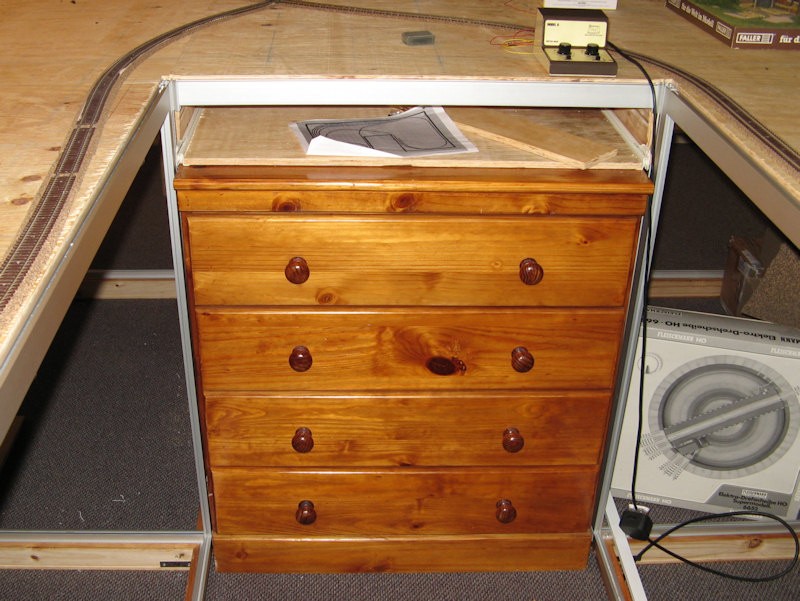 The center of the inverted &quot;U&quot; holds a chest of drawers - both for storage and support.