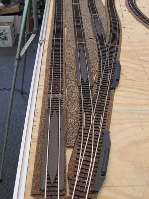 Close up of the re-railers. Since the track work is "hidden" reliability is required, so after every trailing point where the track work is covered, re-railers have been placed.