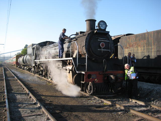 2650 stands ready to depart from Hermanstad. Train Manager Steve A stands by the buffer beam while Trainee Driver Steve S brushes down the boiler