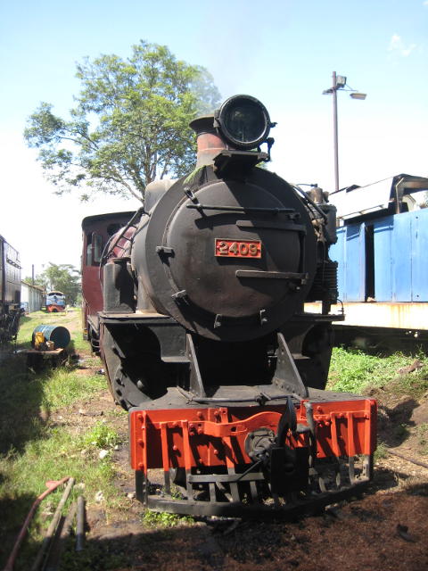 2409 stands in the sun with just a faint haze of smoke beginning to appear from her chimney