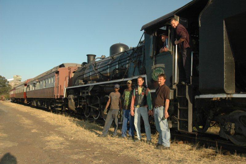 In the cab, driver Frik Boshoff at the door, with Fireman Dewald Heydenrych. On the ground is driver Arno Grundling who helped shunt. Local Community Forum Security person "Chopper" with site helpers, Welcome and Raymond and of course "JoAnna" our class 24.