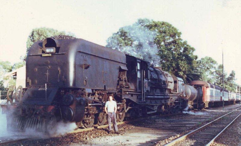 Whilst the railways of Rhodesia were having a motive power shortage, many class GMAM were sent up there for a while. After returning from Bulawayo to Capital Park, they were put into service on construction trains and with a bit of a push, were placed on the Cullinan line. Seen here before the 06:15 departure is GMAM 4061 and the Fireman Nathan with his wife's name "LINDIE" on the bunker. Only this side of the loco was cleaned for the photographers, otherwise these locomotives were dirty. 1981