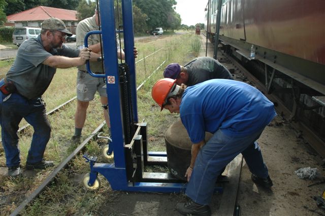 One of our finest investments so far has been this hydraulic lift. Grunting and groaning, the FOTR weekenders place the repaired vacuum cylinder onto<br />the lift, and soon it will be united with its coach. <br /><br />Photo Miemie Wolmarans 09/02/08