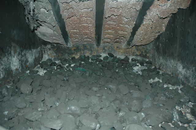 Firelighting steps. The firegrates are covered with a layer of coal. Next step is the wood and match!