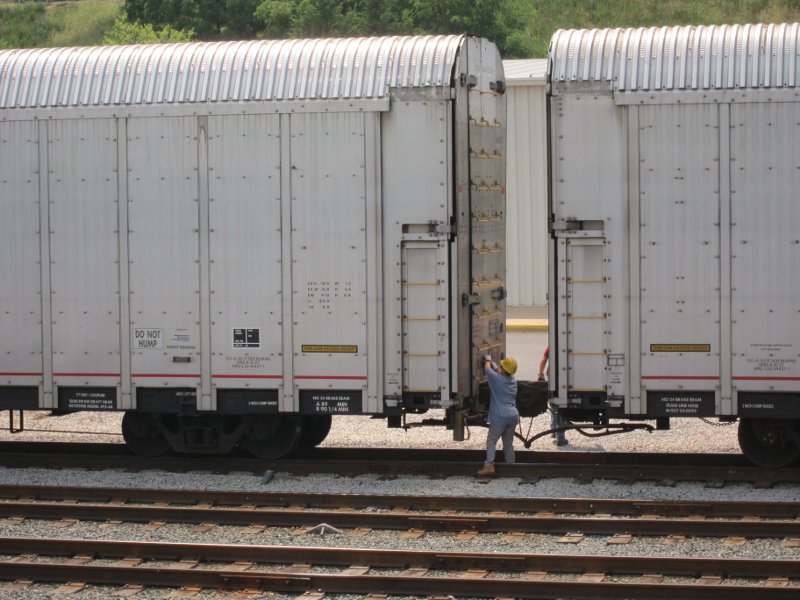 Inter-truck ramps have been stowed and doors being closed for departure.