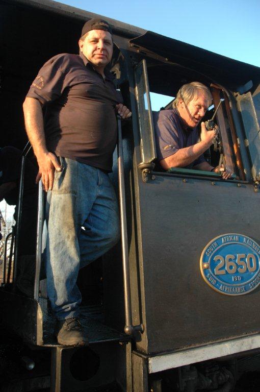 Having just passed out as steam train drivers, "Drivers" Gabor Kovacs and Tony Attwell pose in the cab of 2650 after returning with a charter from Cullinan