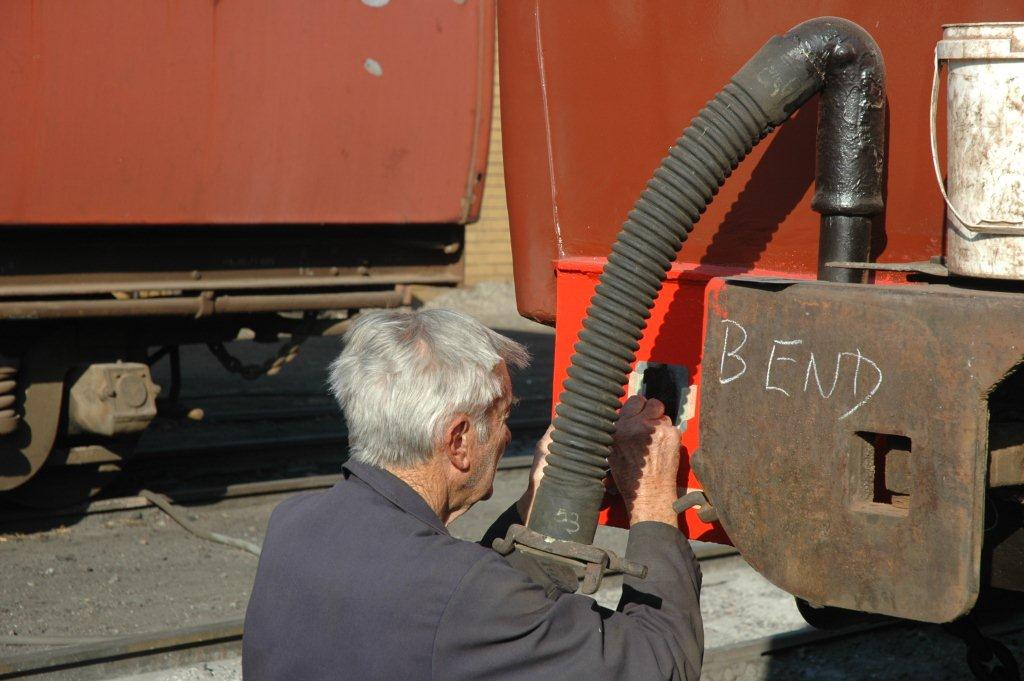 John Dadford the artist at work stenciling "B" on the buffer to mark that end of the coach and not "BEND" as it may seem from the chalk mark! August 2012