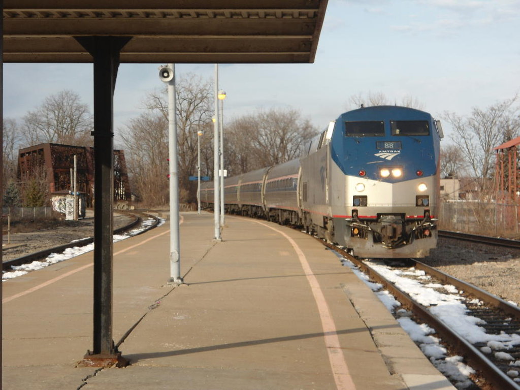 An Amtrak train arrives at Schenectady Station in clear sunlight, albeit with a chill in the air