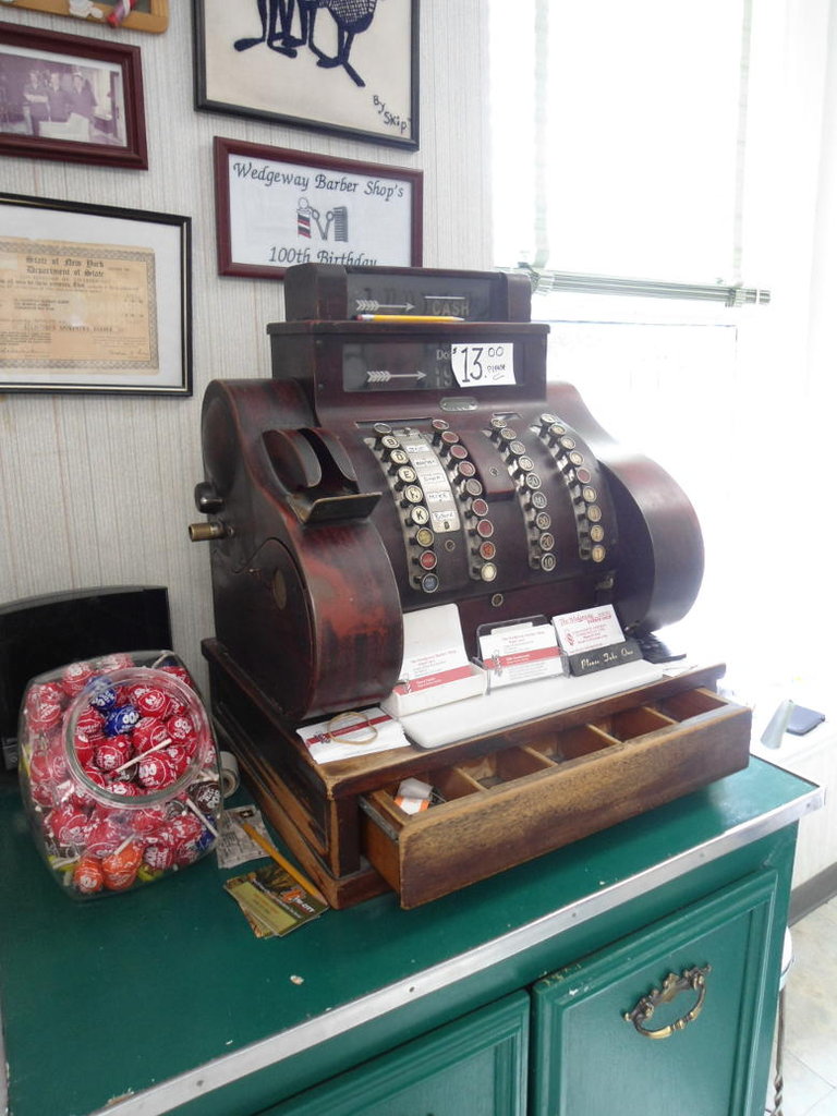 Not a station, but right across the road from Schenectady Station and very convenient for a quick haircut and hot shave while waiting for a connection is a 100-year old barber's shop, with the original cash till still in use