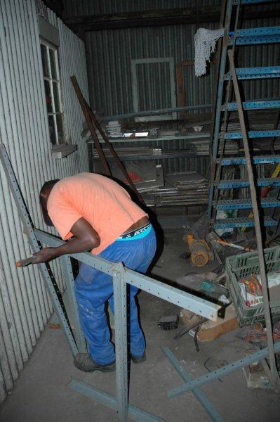 Chris gets to work loosening up shelving that was kindly donated to us from Xerox by Steve Smith. This is in the large shed and was built to take the track tools and general gardening tools