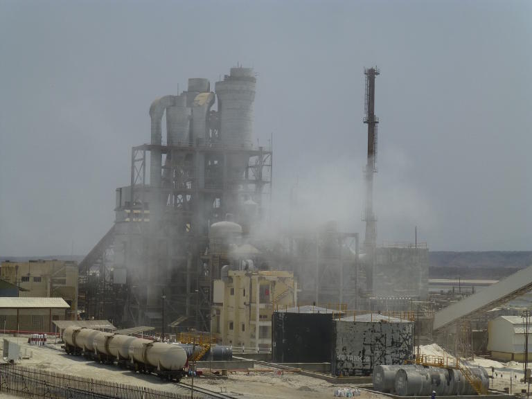 Tank cars visible in the factory