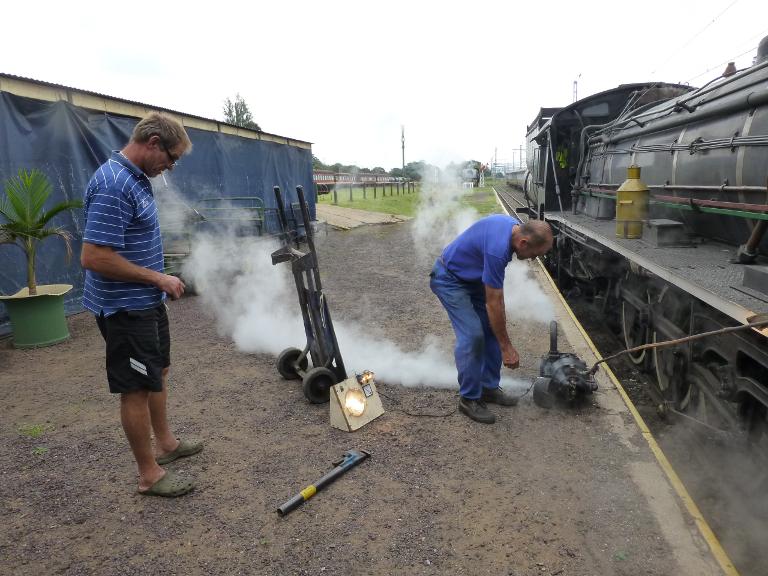 Robert tests a dynamo while Chopper looks on