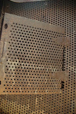 Inside the tender are a number of baffle plates that are fitted to control the forward and rearward movement of the water during the locomotive movements. Here we see the access door to the depths of the tender. The hinges have unfortunately rusted and will need to be replaced. At the time the photo was taken, it was stinking hot in here!
