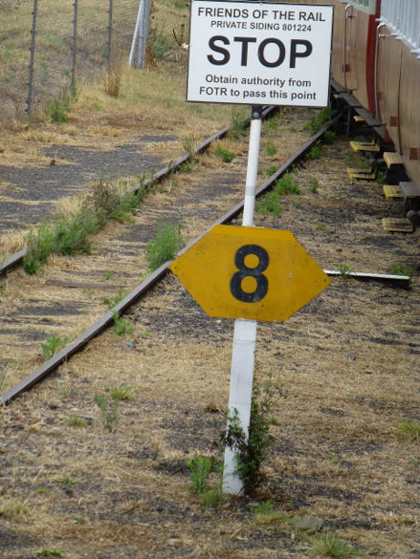 The rear of the train has now pushed back beyond the stop board, having received authority from the shunters to pull up to the signal