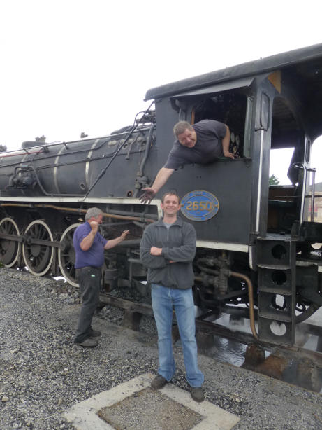 Gabor and Zane pose while Tony continues working