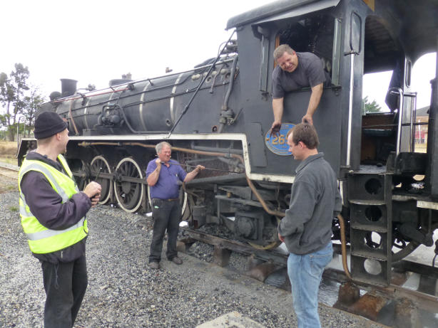 Philip, Zane and Gabor chat as Tony rakes out the ash pan after cleaning fire