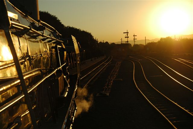 "The 25NC is approaching the signals at Modderpoort . Soon it will be time to clean fire and take water, before proceeding into the fading light with her passenger train."<br /><br />If only! Class 25 at Rovos Rail site awaiting  passengers whilst posing at their platform.