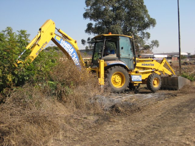Grubbing out some scrub between the platform and the future car park