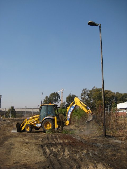 Grubbing out some scrub between the platform and the future car park