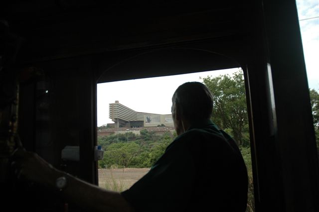 World renowned UNISA building framed in the cab window of 19D number 3360, as she trundles downgrade to Capital Park with 14 coaches in tow. The driver perhaps is doing a correspondence course there