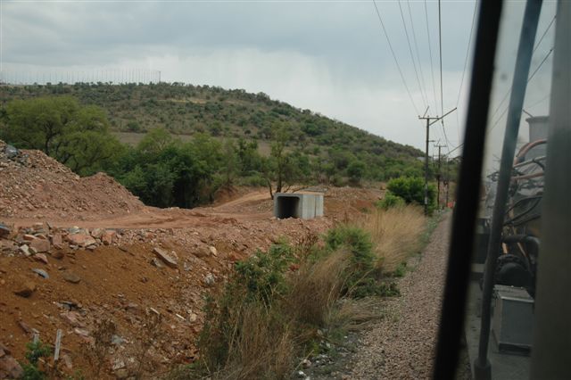 Freedom Park flagpoles on the skyline look onto a changing railway scene, as the Gautrain earthworks take shape close to Pretoria station. The 19D on the Rovos Rail train may someday be pacing the new train set