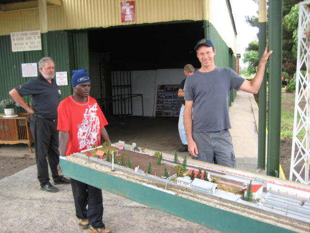 Kobus and Chris watch the layout being carried in<br /><br />Photo by John