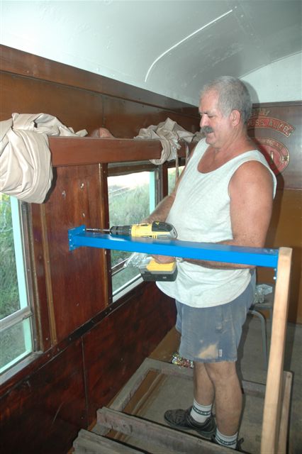Pekenese fastens the steel powder coated support to the wall of the once open-plan coach. Soon the seat cushions will be fitted and she will be able to accommodate passengers and, with the double door access, she will be able to take wheelchairs and thus be of great help to persons with disabilities.