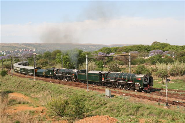 It's jacaranda time in Pretoria again. To celebrate this, a Rovos NC doubleheader departs CP on her way to the Cape. The leading loco, the diesel burner 3484, failed later on near Pretoria station.