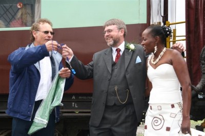Nathan bestows a whistle and green flag upon John, who will send his train on the way - C Janisch