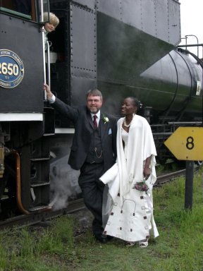 John tries desperately to get onto the footplate but Jane is adamant