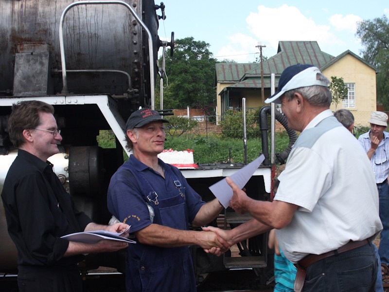 Another FOTR stalwart, Lt Col Eric Samuels (ret) receives his certificate from Nathan while Courtney looks on.<br />By Kevin Wilson-Smith.