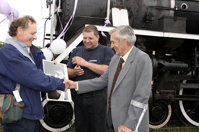 Nathan makes the presentation to Uncle John while Gabor looks on