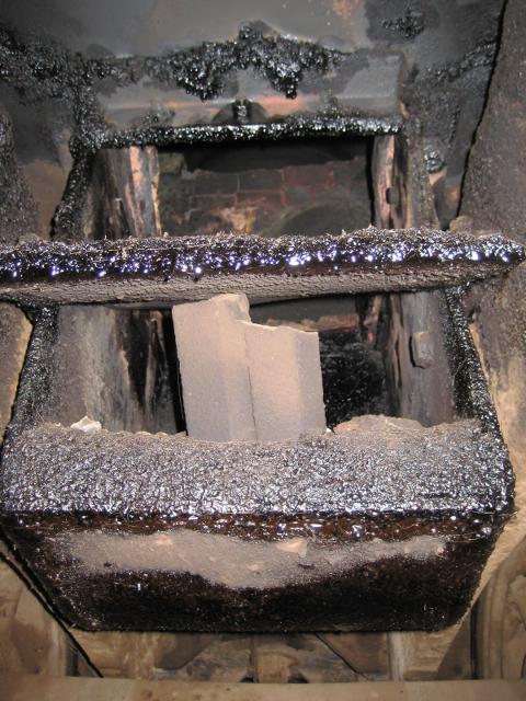 This is the botton of the firebox, where an ashpan hopper would be on a coal-fired loco. The horizontal flap in the middle appears to be a damper that can be opened and closed