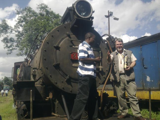 Maurice Barasa, curator of the railway museum, and John Ashworth pose on the loco