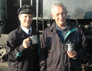 Nathan and Cliff proudly display their Swedish gifts. The conductor's uniform of Nathan's with the windbreakers, issued to Swedish railway personel. The stainless steel mugs, well, they are etched with Cliff and Nathanâ€™s last regular locomotive they had when they were a regular crew back in the old days, on 15F 3127.