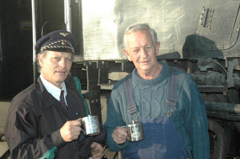 A long partnership. Cliff Petzer and Nathan Berelowitz pose with their wonderful gift of an engraved stainless steel mug sent all the way from Sweden by fellow steam freak, Goran Enqvist. The sexy outfit Nathan is wearing is a Swedish conductor's uniform. Behind them is 15F 3117