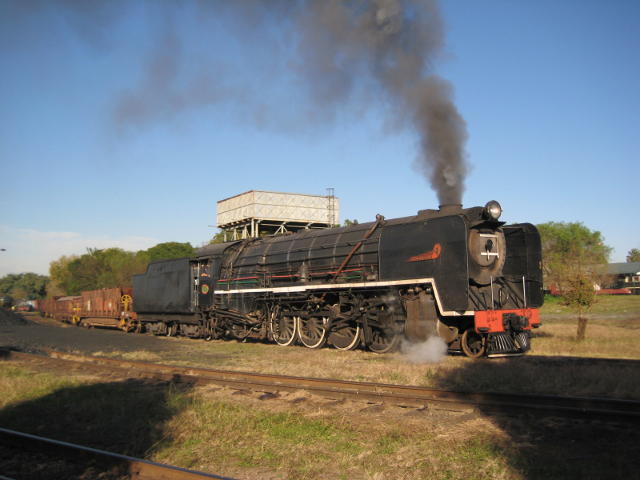 3117 steams through a patch of sunlight amidst the evening shadows