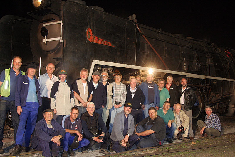 3117 forms the backdrop as photographers and crew pose together at the end of a long but productive day
